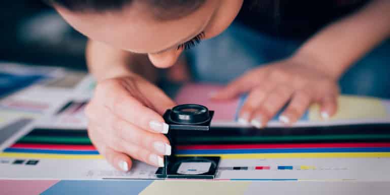 Young woman working in printing factory. Printing Press Werbetechnik: Druckmedien