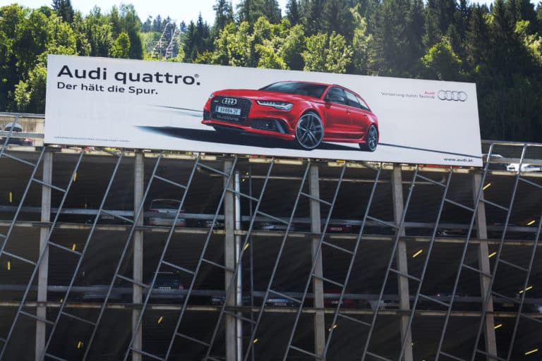 Schladming, Austria - August 15, 2017: Audi quattro car poster on parking house on August 15, 2017 in Schladming, Austria. Audi Starts Training Its Employees On Big Data And A.I. Werbetechnik: Werbe- und Firmenschilder von Eckstein Foliensysteme in Weißenburg!